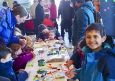 A young attendee enjoys the 4-H Council craft table.