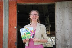 Hemp expert Anndrea Hermann on her farm near Kleefeld, Man., with the fruit of her translation efforts, a hemp-based children’s book.
