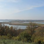 The shores of Pelican Lake spread out under the Ninette viewpoint.