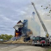 Fire crews work to extinguish the fire that destroyed the decades-old grain elevator in St. Jean Baptiste.