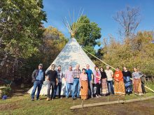 Stewards of Wabano Aki at the ceremonial grounds: (L-R) Ken Norquay, Fayaz Hasan, Jeremy Hogan, Kevin Teneycke, Gordon Beddome, Midge Stace, Cary Hamel, Rebekah Neufeld, Christine Chilton, Josh Dillabough, Wendy Norquay, Lauren James and Karine Whitcher.