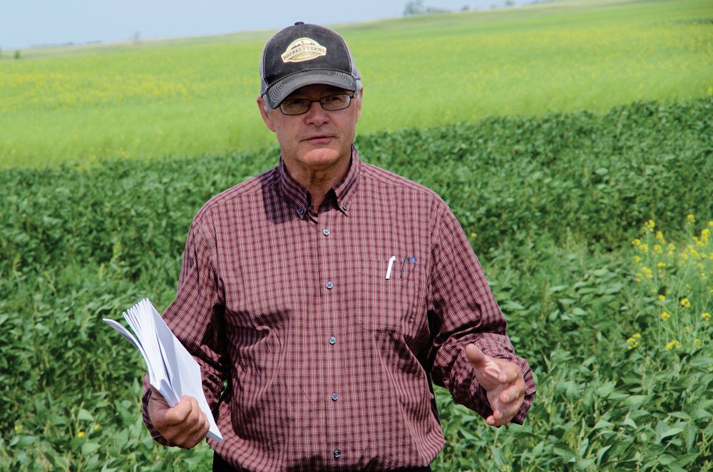 David Rourke takes field tour attendees through his on-farm trials in mid-2022.