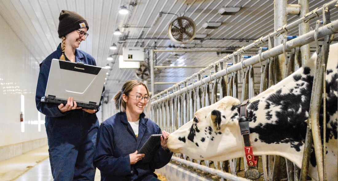 Dairy barn: left to right, U of M students Brittany Bedard and Rhea Teranishi.  Photo is courtesy of University of Manitoba.