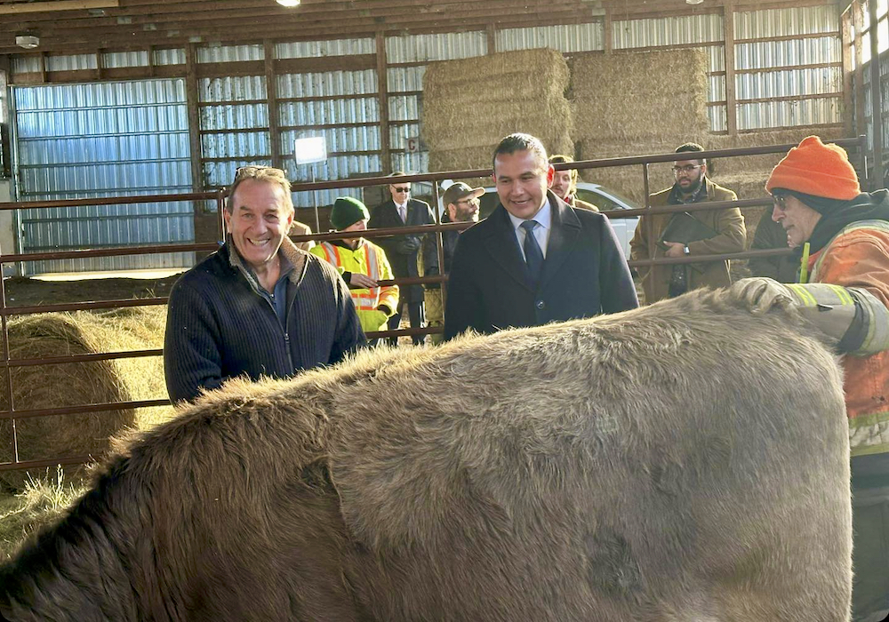 Manitoba Agriculture Minister Ron Kostyshyn (left) and Premier Wab Kinew (center) at the Nov. 24 announcement regarding financial assistance on Crown land lease payments.