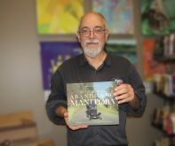 Gordon Goldsborough poses with the recently released third book in his Abandoned Manitoba series.