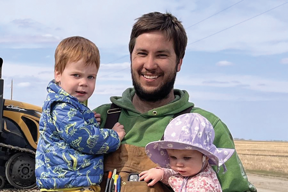Carman-area farmer Tyler Menold with his kids.