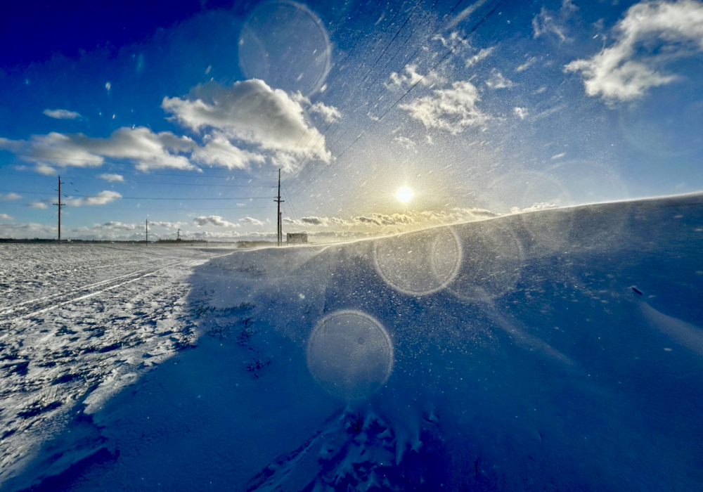 Blowing snow catches the light Dec. 17 north of Russell. Sustained winds in the region reached 31 kilometres an hour, with gusts up to 55, following a fresh snowfall.