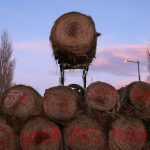 A hay bale is moved by a tractor over a pile to block a road, as French farmers protest over price pressures, taxes and green regulation, grievances shared by farmers across Europe, near Castelnaudary, in the south of France, January 23, 2024. The text on the hay bales reads: “JA” referring to “Jeunes Agriculteurs” (Young Farmers) and “We just want to feed, not die”. Photo: Reuters/Nacho Doce