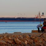 FILE PHOTO: People walk on the beach as a container ship crosses the Gulf of Suez towards the Red Sea before entering the Suez Canal, in El Ain El Sokhna in Suez, east of Cairo, Egypt April 24, 2017. Picture taken April 24, 2017. Photo: Reuters/Amr Abdallah Dalsh