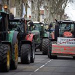 Farmers protesting in Toulouse, France, on January 16, 2024, with tractors bearing placards that read ‘Macron still an effort, soon all farmers will be dead’. Photo by Alain Pitton/NurPhoto via Reuters