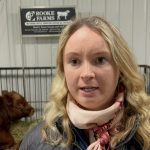 Cattle breeder Alice Rooke stands in front of her livestock at Manitoba Ag Days 2024.