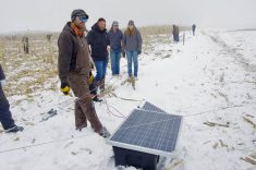 Tour attendees check out Brett McRae’s solar fencing system during a January 2024 field tour.