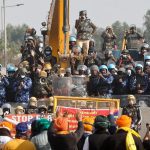 FILE PHOTO: Farmers gesture towards police officers at the site of a protest as they march towards New Delhi to press for better crop prices, at Shambhu barrier, a border crossing between Punjab and Haryana states, India, February 21, 2024. REUTERS/Francis Mascarenhas/File Photo