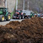 Farmers drive tractors in front of government office, where they dumped manure, during a protest against European Union agricultural policies, grievances shared by farmers across Europe.
