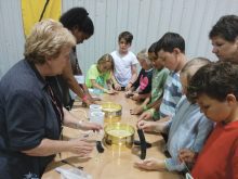 Attendees try their hand at wheat grinding during the Amazing Agriculture Adventure June 6-7.  Photo: Agriculture in the Classroom Manitoba
