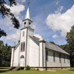 St. Lupicin Roman Catholic Church features well-treed grounds.