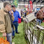 Bert Tichelaar (right), owner of Aryquip Ltd., discusses how Aryquip pig sorter software could be mounted on an existing sorter with Peter Mettler (left) who runs a 300-sow farrow-to-finish operation in Ontario.