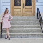 Trina Semenchuk, founder of The Little Greenhouse That Could, standing in front of Government House at the Manitoba Legislative Grounds.