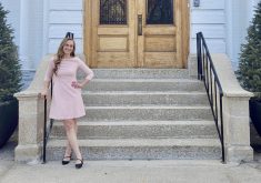 Trina Semenchuk, founder of The Little Greenhouse That Could, standing in front of Government House at the Manitoba Legislative Grounds.