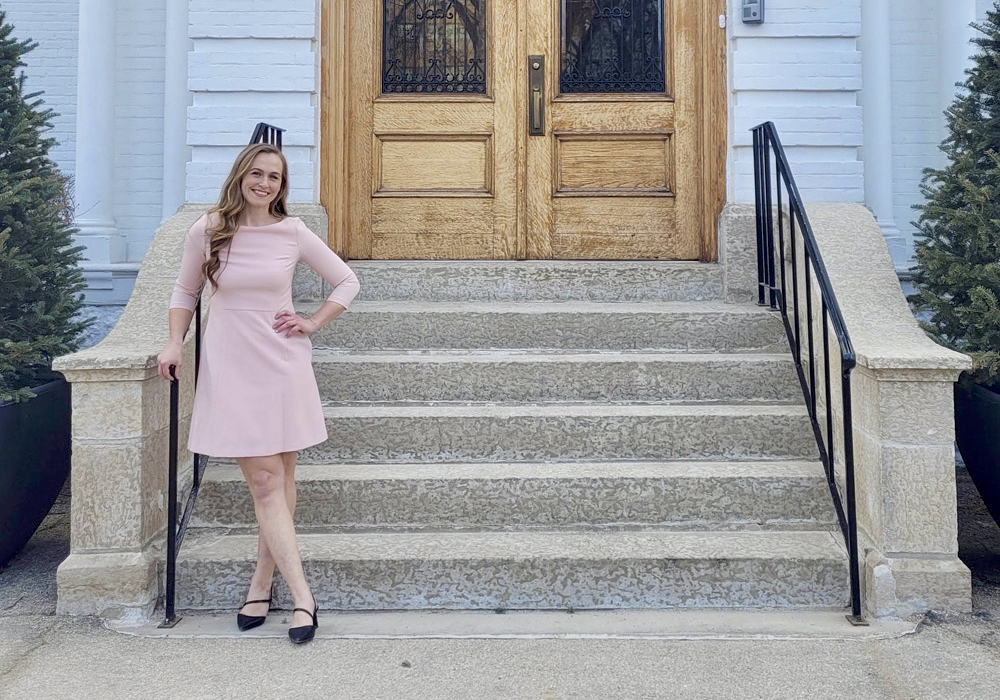 Trina Semenchuk, founder of The Little Greenhouse That Could, standing in front of Government House at the Manitoba Legislative Grounds.