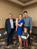 Canada’s Outstanding Young Farmers program president Danny Penner (left) poses with Marcus and Paige Dueck and their children Sutton (lower right) and Brielle (being held by her mother).