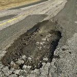A large pothole down the centre of a lane on PTH 244 north of Manitou, Man.