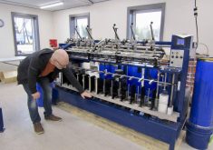 Bryan Driedger demonstrates spinner operation at the April grand opening of the Austin Woollen Mill.