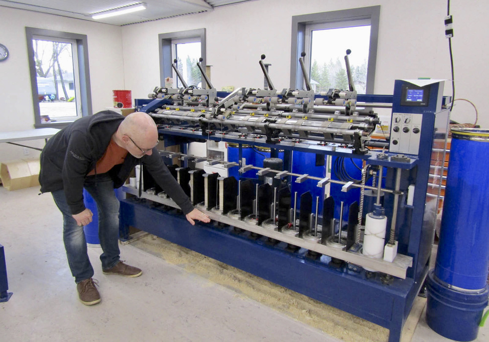 Bryan Driedger demonstrates spinner operation at the April grand opening of the Austin Woollen Mill.
