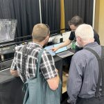 FeedFlo’s Ethan Chochinov demonstrates his company’s product at the World Pork Expo in Des Moines, Iowa. Photo: Ed White
