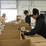 Workers at Arctic Buying Company Kivalliq Inc. pack hampers that will be shipped up to Canada's north.