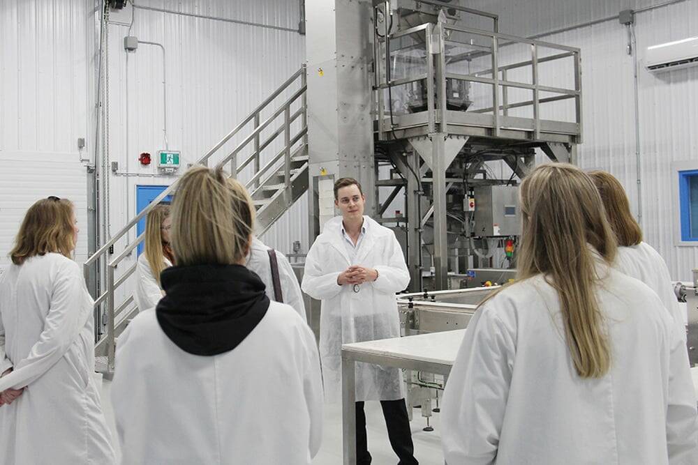 Delta 9 CEO John Arbuthnot shows a tour group Delta 9’s automated packaging line in early 2020. Photo: Geralyn Wichers