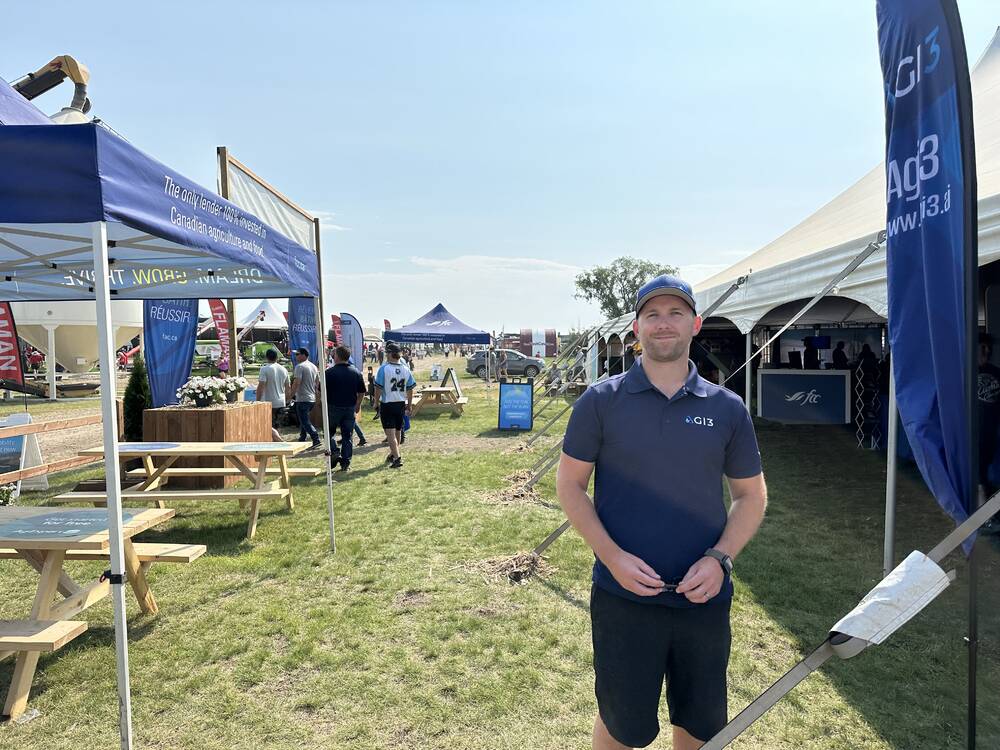 Kyle Gibson of AGI3 outside his company's booth at Ag in Motion