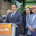Premier Wab Kinew making an announcement in front of a podium.