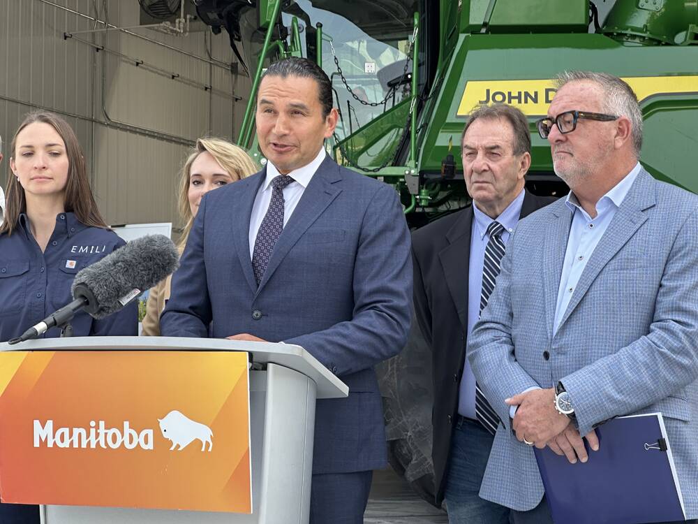 Premier Wab Kinew making an announcement in front of a podium.