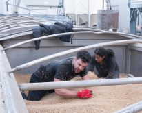 Contestants on The Amazing Race Canada dig through oats for a hidden object. Photo: The Amazing Race Canada/Facebook
