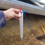 Grain prober trap being placed in grain bin.