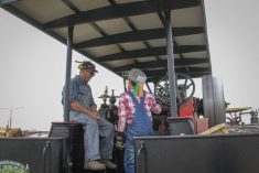 Andy MacMillan and Max Farquhar aboard a steam engine at the Manitoba Agricultural Museum on July 25. 