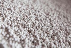 Close-up of white granules of phosphoric fertilizers on fertilizers factory.