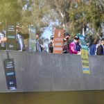 Protesters hold up signs during a National farmers rally outside Parliament in Canberra, Tuesday, September 10, 2024. (AAP Image/Lukas Coch) 
