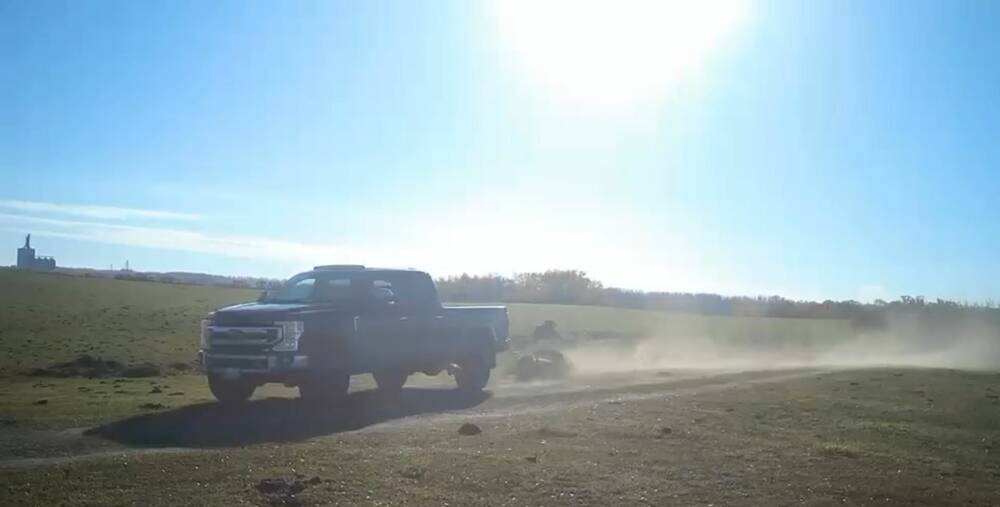 A still from one of Brendan Liske's trail cameras capturing a black truck hauling away the carcass of a bison.