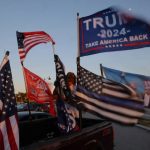 Flags supporting president-elect Donald Trump fly Nov. 11, 2024.  