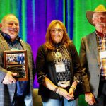 (Left to right) Lawrence Knockaert and Shauna Breault are inducted onto the Manitoba Forage and Grassland Association wall of fame Nov. 12 by MFGA chair Mike Duguid.