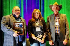 (Left to right) Lawrence Knockaert and Shauna Breault are inducted onto the Manitoba Forage and Grassland Association wall of fame Nov. 12 by MFGA chair Mike Duguid.