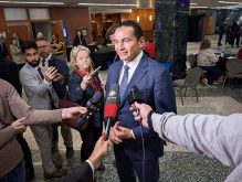 Manitoba Premier Wab Kinew speaks to media after a question and answer session with AMM delegates on Nov. 26.