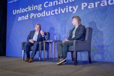 FCC economist Craig Klemmer (left) speaks with Kyle Hiebert, manager of public policy and stakeholder engagement with tech accelerator EMILI, during the Agriculture Enlightened Conference on Nov. 7, 2024.