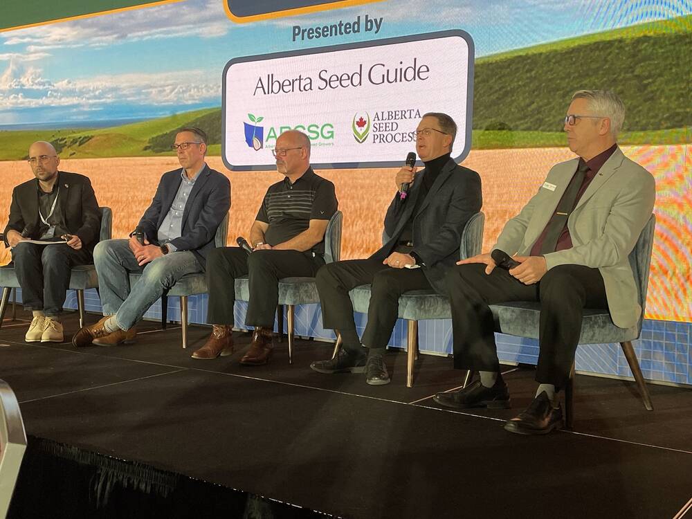 (left-right) Panel moderator Marc Zienkiewicz, SeCan’s Todd Hyra, University of Saskatchewan researcher Stuart Smyth, retired AAFC breeder Robert Graf and Canadian Wheat Research Coalition chair Dean Hubbard discuss what happens if Agriculture and Agri-Food Canada bowing out of field-ready wheat development during the CrossRoads Crop Conference Jan. 28-29 in Edmonton. 