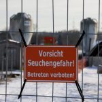 FILE PHOTO: A sign with the inscription  “Beware of epidemic danger! No trespassing!” hangs on a fence in front of a farm in Mehrow, close to Ahrensfelde, Germany, January 13, 2025.    REUTERS/Axel Schmidt/File Photo
