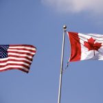 American and Canadian flag flying side by side.
