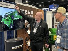Trevor Thiessen of Redekop Manufacturing explains the company’s straw chopper to a farmer from Oregon at the Commodity Classic in Denver, Colorado, March 4. Redekop and other Canadian manufacturers are adjusting to 25 per cent tariffs on goods exported to the United States. | Robert Arnason photo
