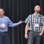 Olymel’s Kevin Brooks (right) explains how to properly position a rattle bat during the Manitoba Swine Seminar Feb. 5, using a member of the audience as an example.